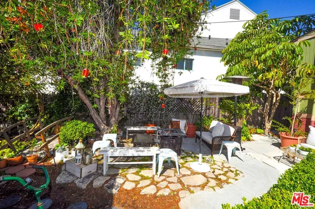 a view of a table and chairs under an umbrella in the patio
