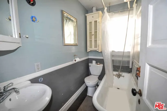 a bathroom with a sink mirror vanity and toilet