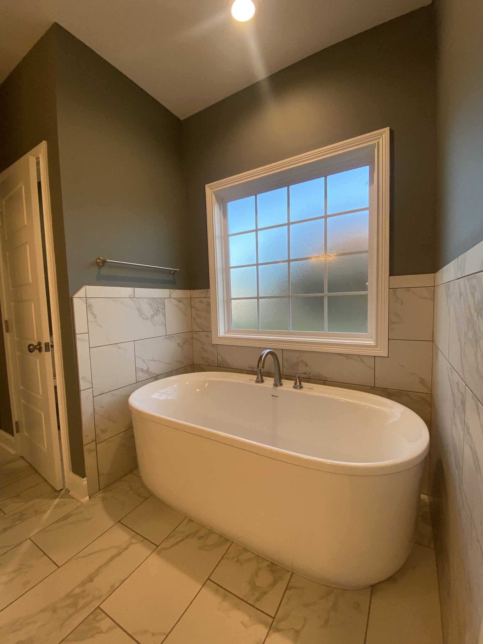 557 Dexter Drive Clarksville, TN 37043 - Photo 14 of 30 a bath tub sitting in a bathroom next to a window