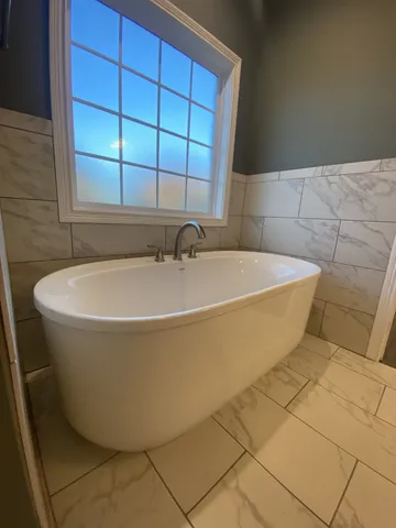 a spacious bathroom with a granite countertop sink and a mirror