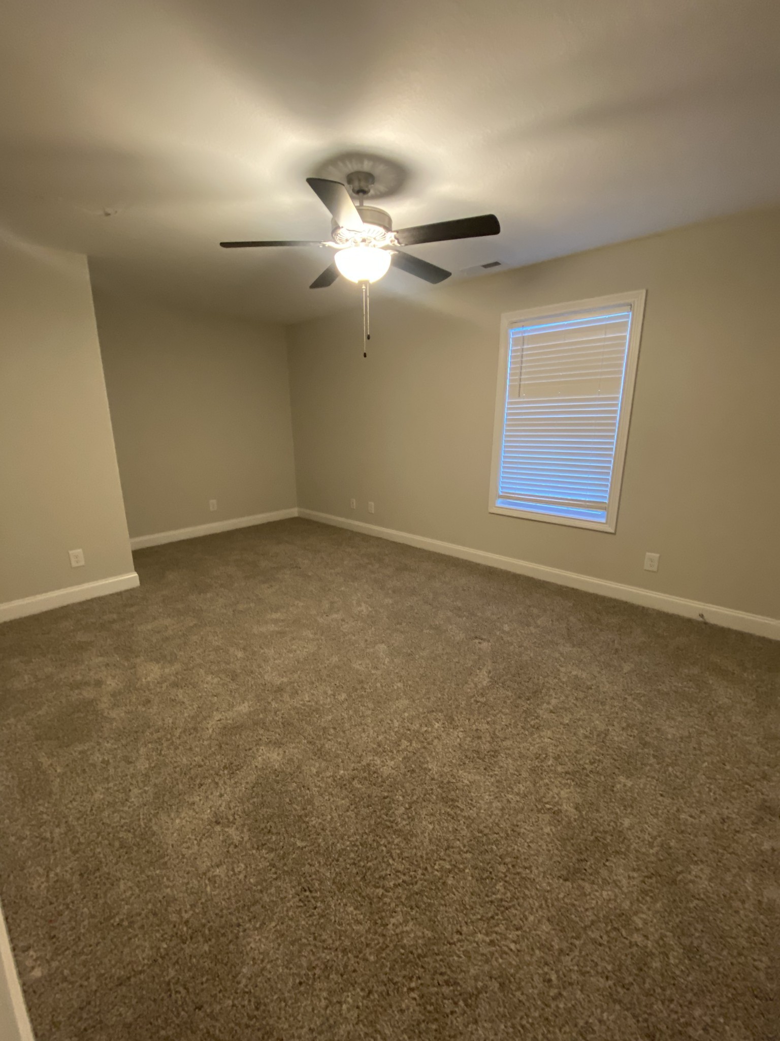 557 Dexter Drive Clarksville, TN 37043 - Photo 23 of 30 an empty room with windows and fan