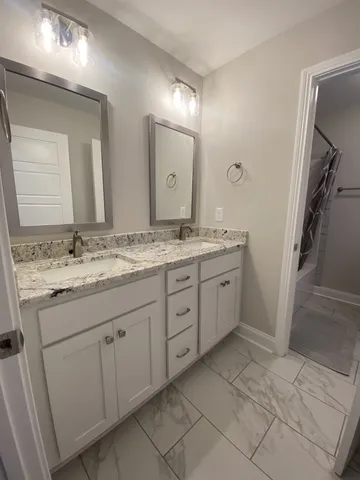 a bathroom with a shower and a bath tub