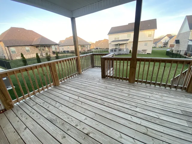 a view of a house with a backyard and porch