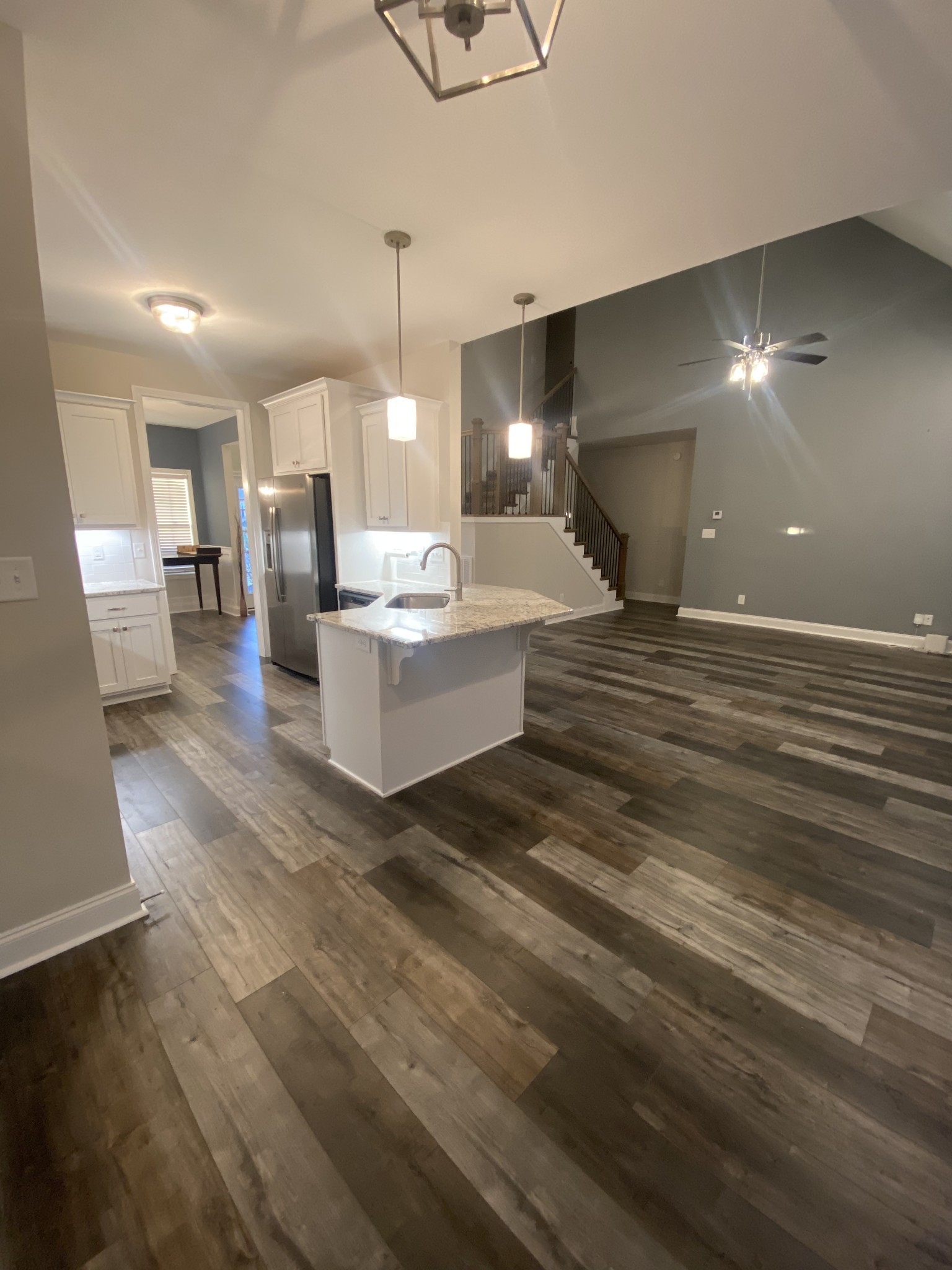 557 Dexter Drive Clarksville, TN 37043 - Photo 7 of 30 a living room with couches and kitchen view with wooden floor