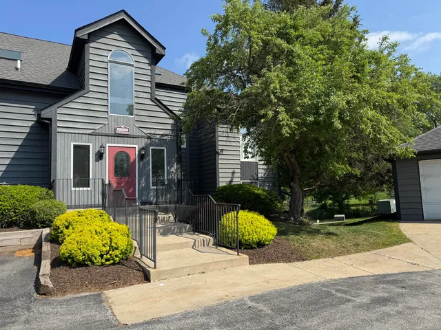 a front view of a house with a yard and porch