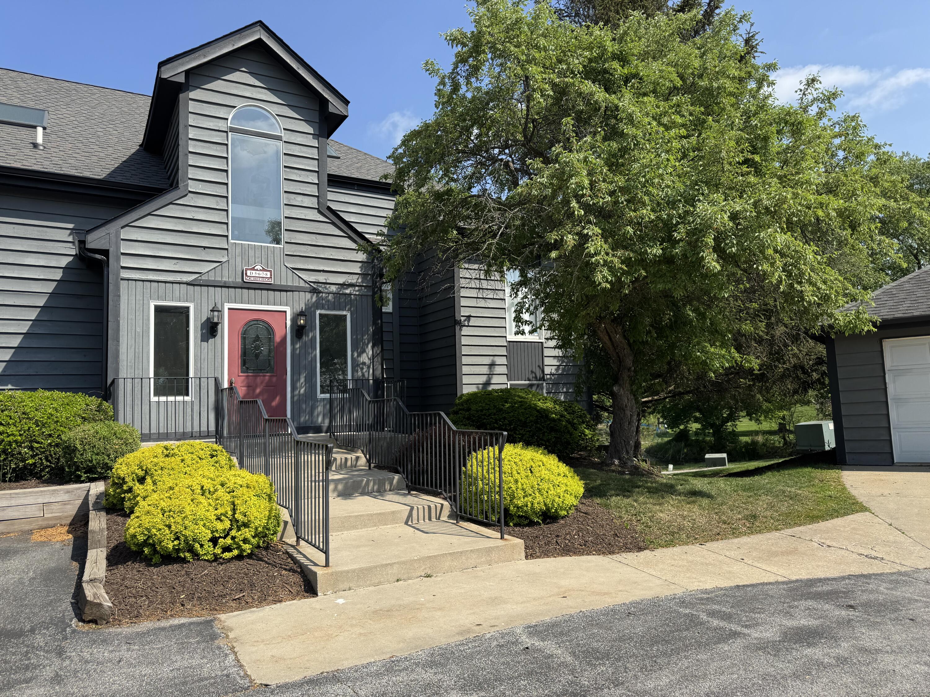 a front view of a house with a yard and porch