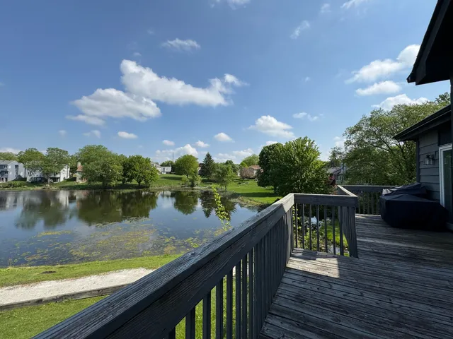 a balcony with wooden floor and lake view
