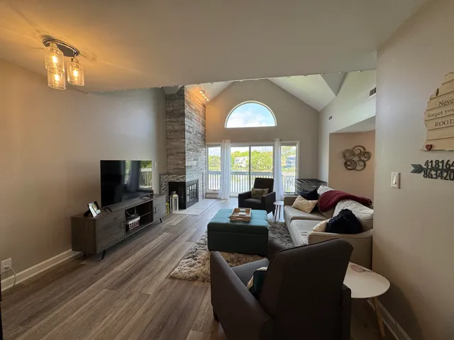 a living room with fireplace furniture and a flat screen tv