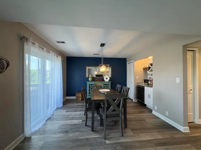 a view of a dining room with furniture window and wooden floor