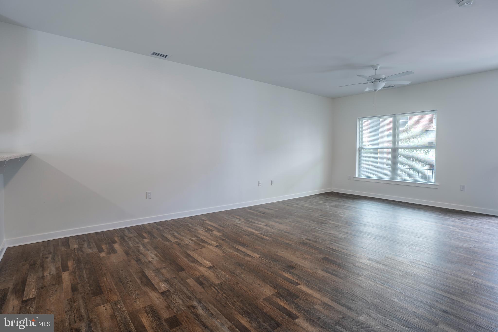 836 Bennett Street Wilmington, DE 19801 - Photo 13 of 66 an empty room with wooden floor and windows