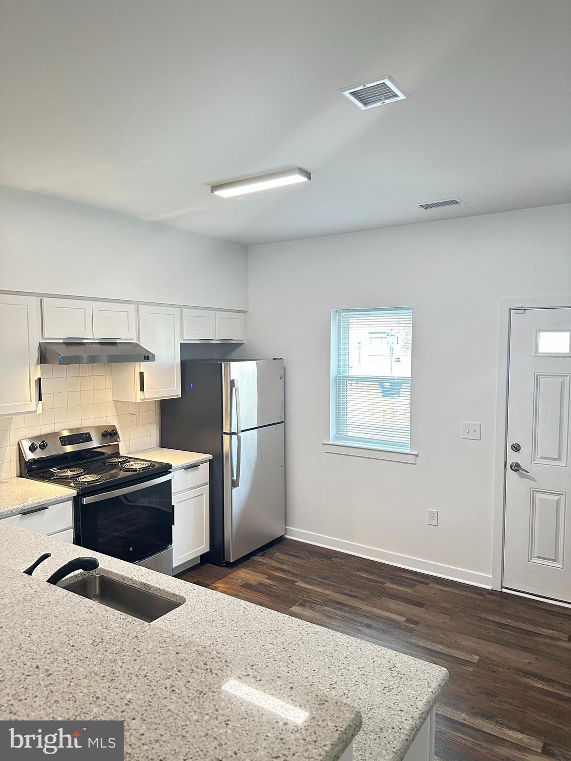 836 Bennett Street Wilmington, DE 19801 - Photo 17 of 66 a kitchen with stainless steel appliances granite countertop a refrigerator a stove a sink and a microwave