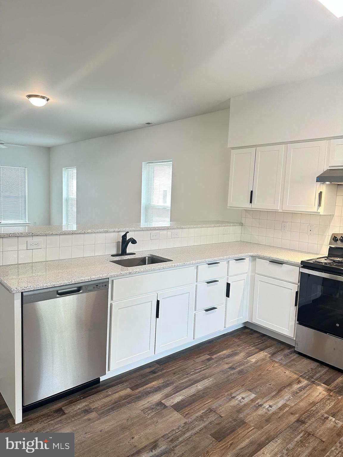 836 Bennett Street Wilmington, DE 19801 - Photo 18 of 66 a kitchen with granite countertop white cabinets and white appliances
