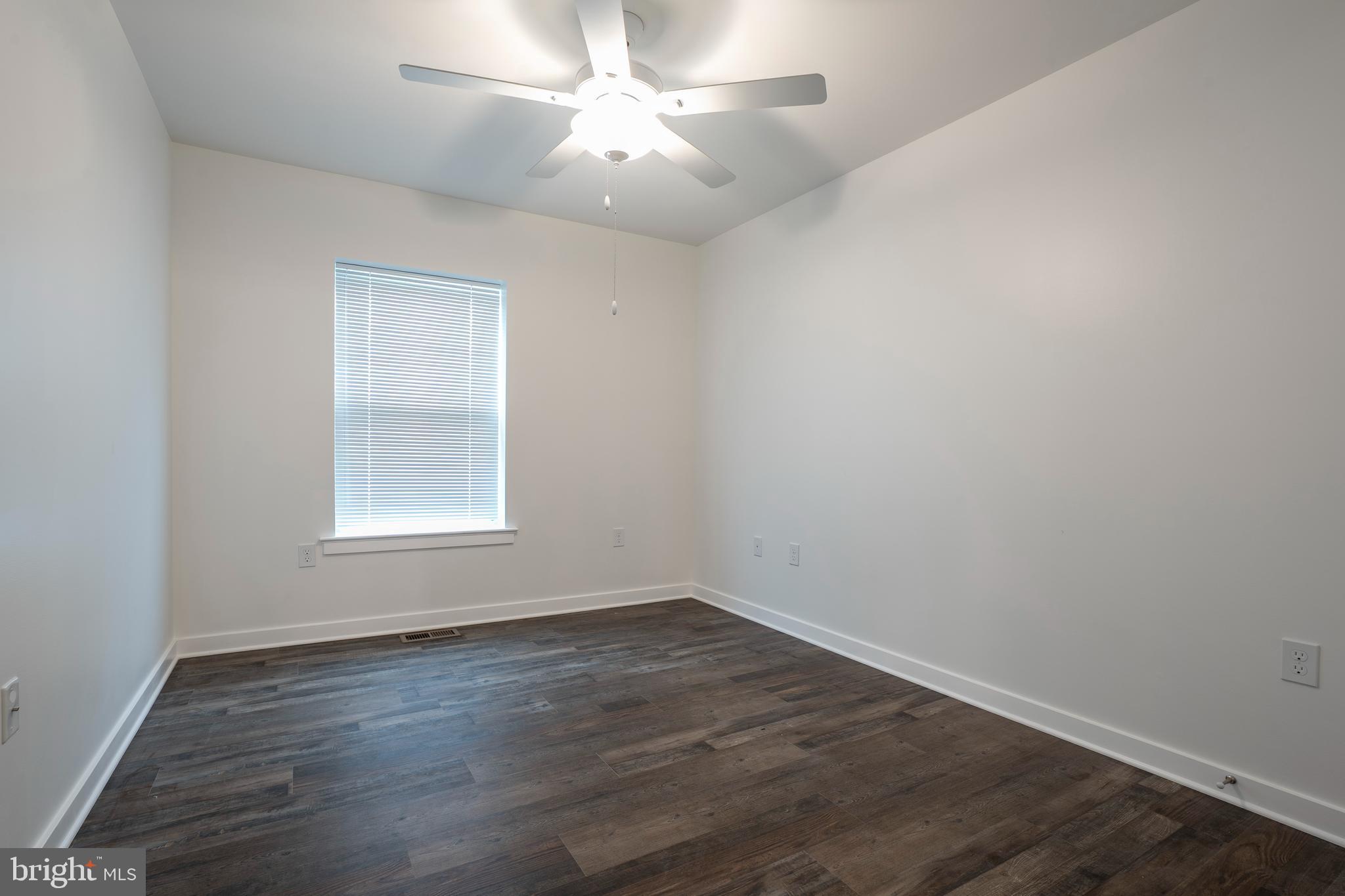 836 Bennett Street Wilmington, DE 19801 - Photo 19 of 66 an empty room with wooden floor and windows