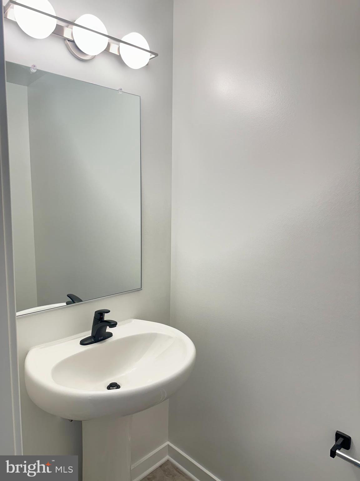 836 Bennett Street Wilmington, DE 19801 - Photo 20 of 66 a bathroom with a sink and mirror