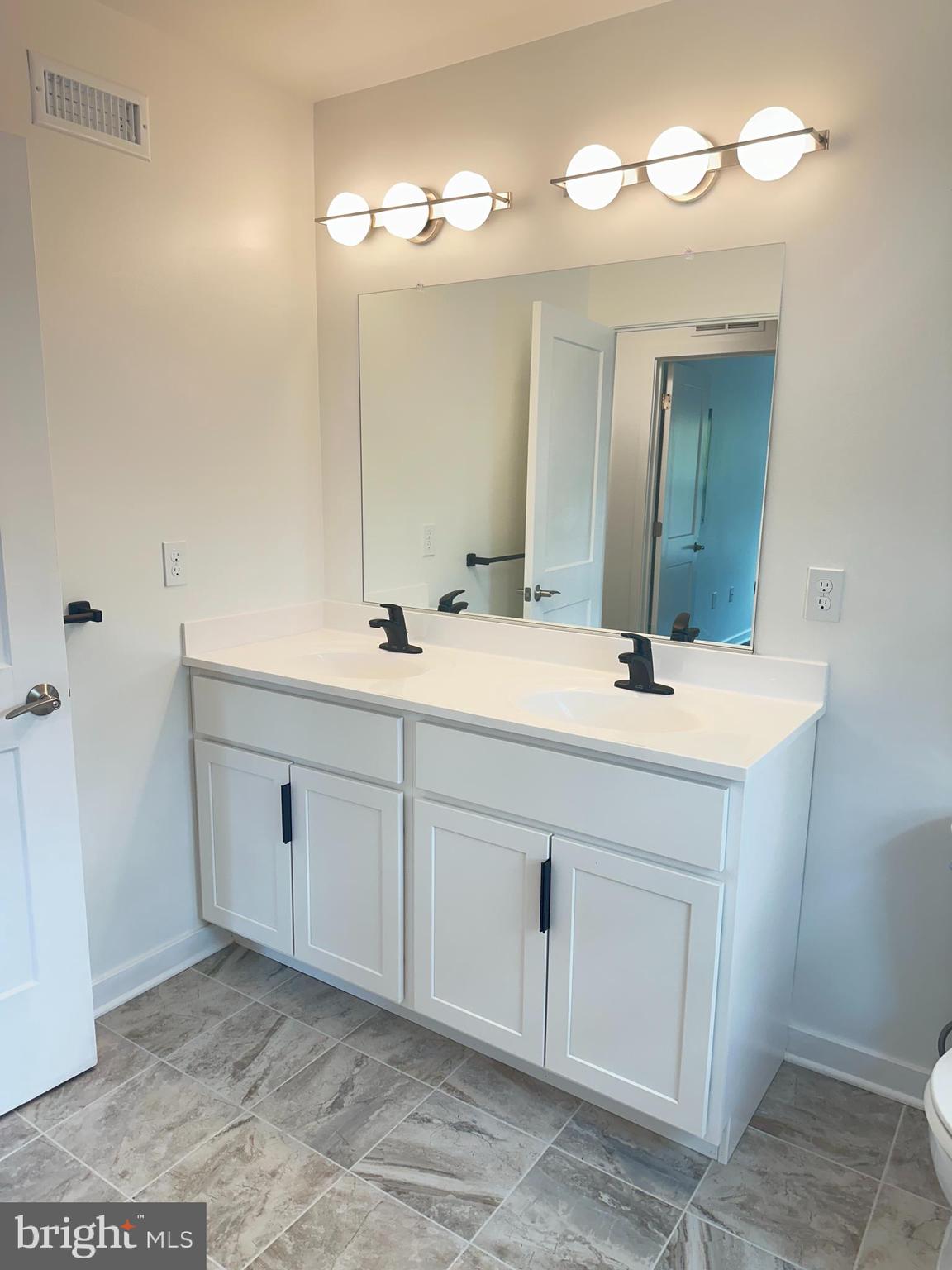 836 Bennett Street Wilmington, DE 19801 - Photo 22 of 66 a bathroom with a double vanity sink and a mirror