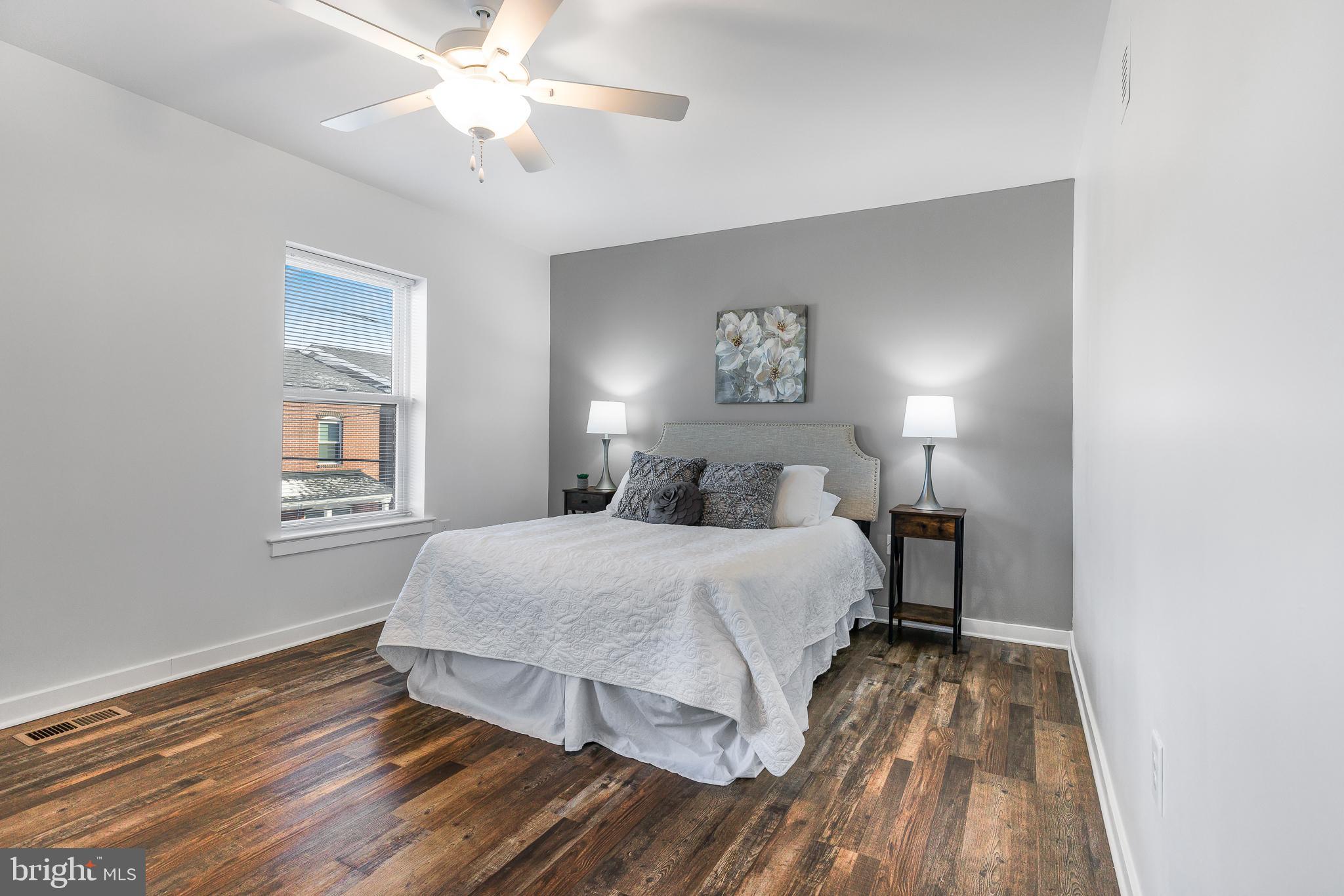 836 Bennett Street Wilmington, DE 19801 - Photo 40 of 66 a spacious bedroom with a bed and a chandelier