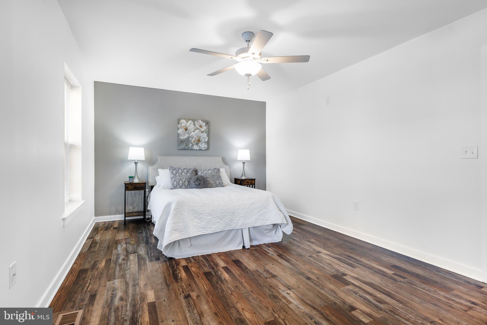 836 Bennett Street Wilmington, DE 19801 - Photo 41 of 66 a bedroom with a bed and a chandelier