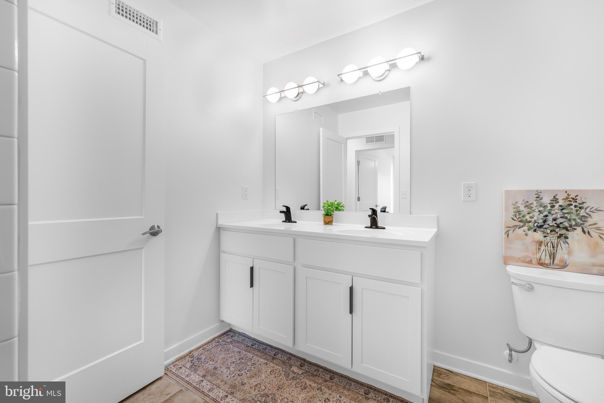 836 Bennett Street Wilmington, DE 19801 - Photo 44 of 66 a bathroom with a sink a toilet and shower