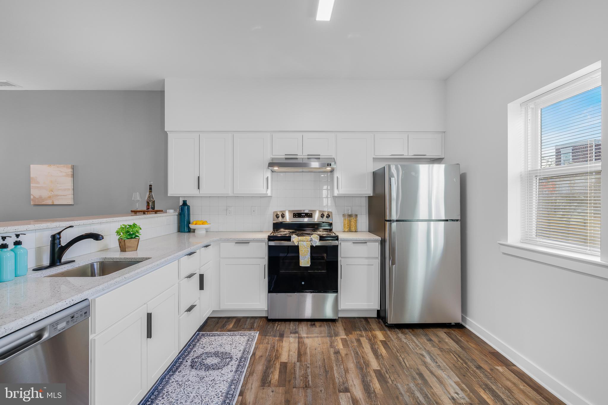 836 Bennett Street Wilmington, DE 19801 - Photo 59 of 66 a kitchen with stainless steel appliances a refrigerator sink and cabinets