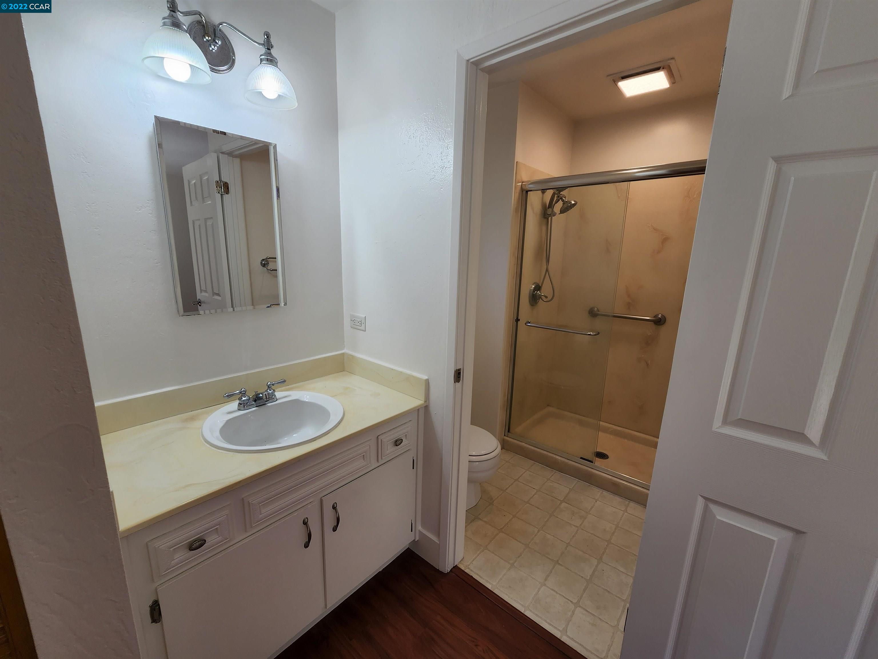 79 Ryegate Place San Ramon, CA 94583 - Photo 16 of 18 a bathroom with a shower sink and mirror