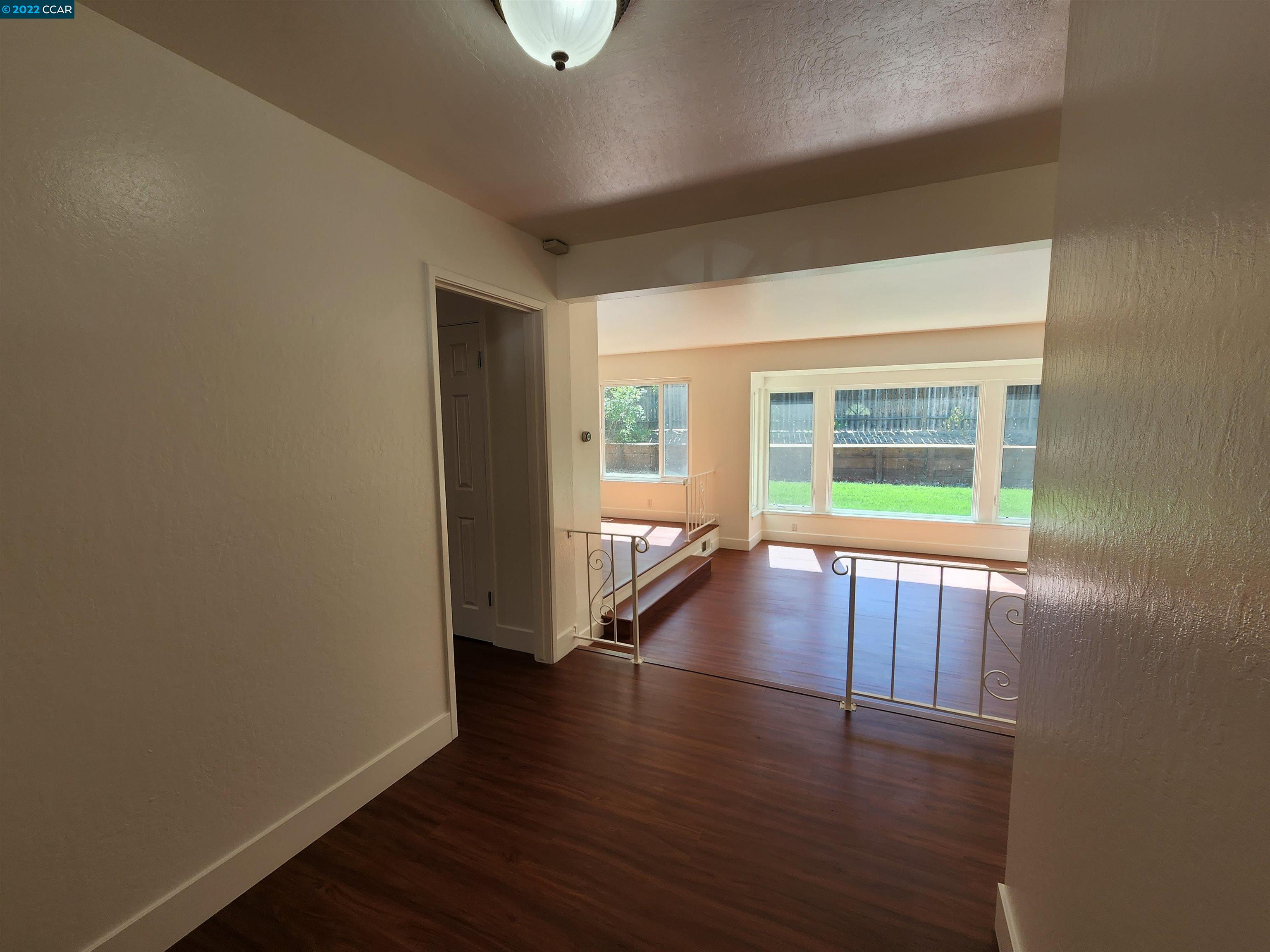 79 Ryegate Place San Ramon, CA 94583 - Photo 2 of 18 an empty room with wooden floor and windows