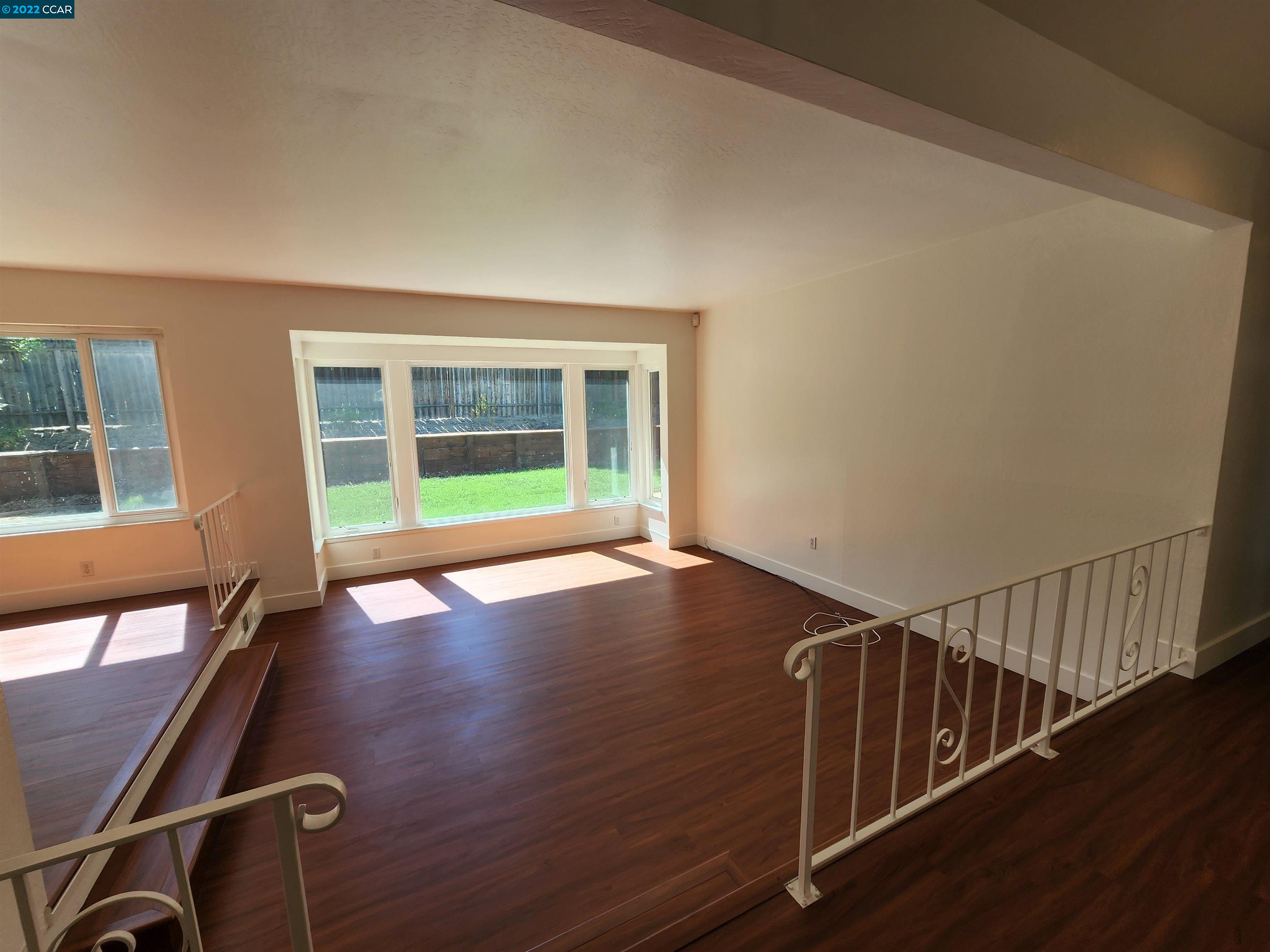 79 Ryegate Place San Ramon, CA 94583 - Photo 3 of 18 a view of an empty room with wooden floor and windows