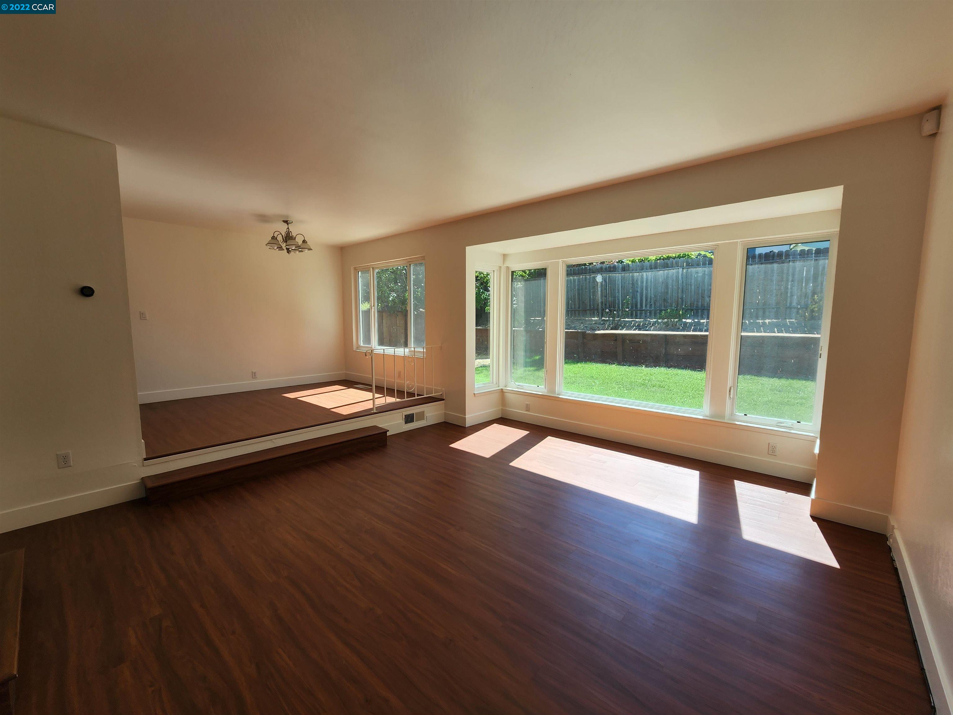 79 Ryegate Place San Ramon, CA 94583 - Photo 8 of 18 an empty room with wooden floor and windows