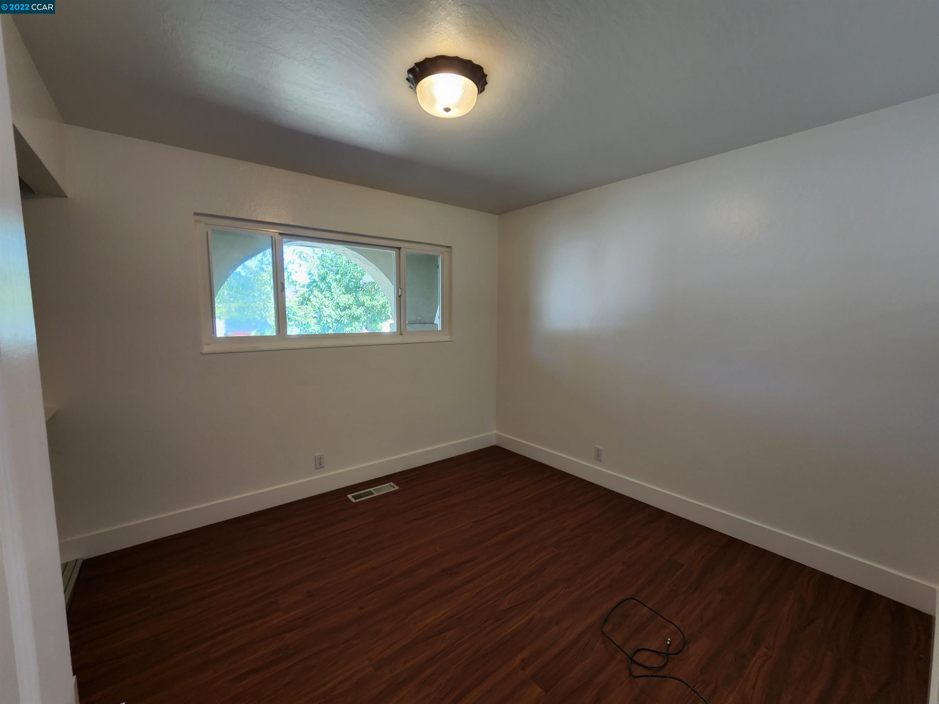 79 Ryegate Place San Ramon, CA 94583 - Photo 9 of 18 an empty room with wooden floor and windows