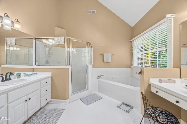 an aerial view of residential house with outdoor space and trees all around