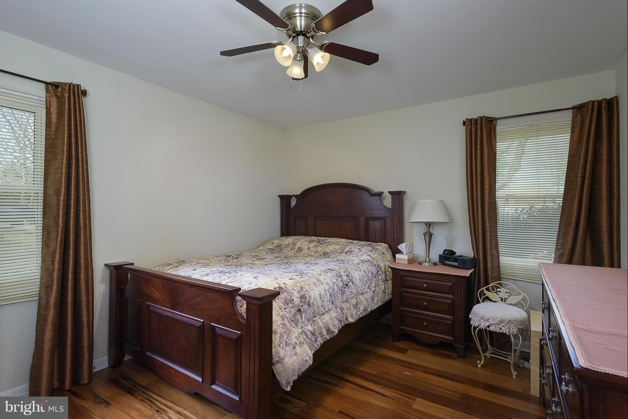 12013 Marvel Lane Bowie, MD 20715 - Photo 19 of 22 a bedroom with a bed and a chandelier