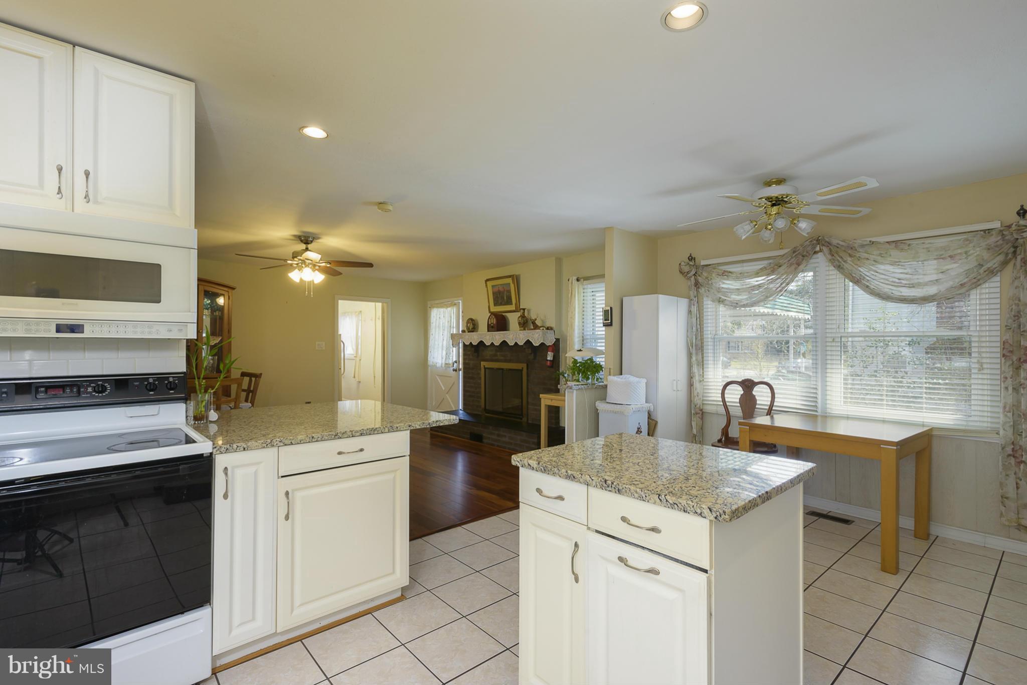 12013 Marvel Lane Bowie, MD 20715 - Photo 9 of 22 a kitchen with a sink dishwasher a stove and a refrigerator with wooden floor