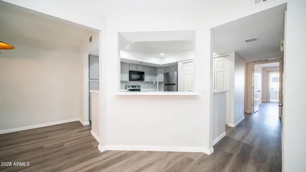 a view of a kitchen with wooden floor