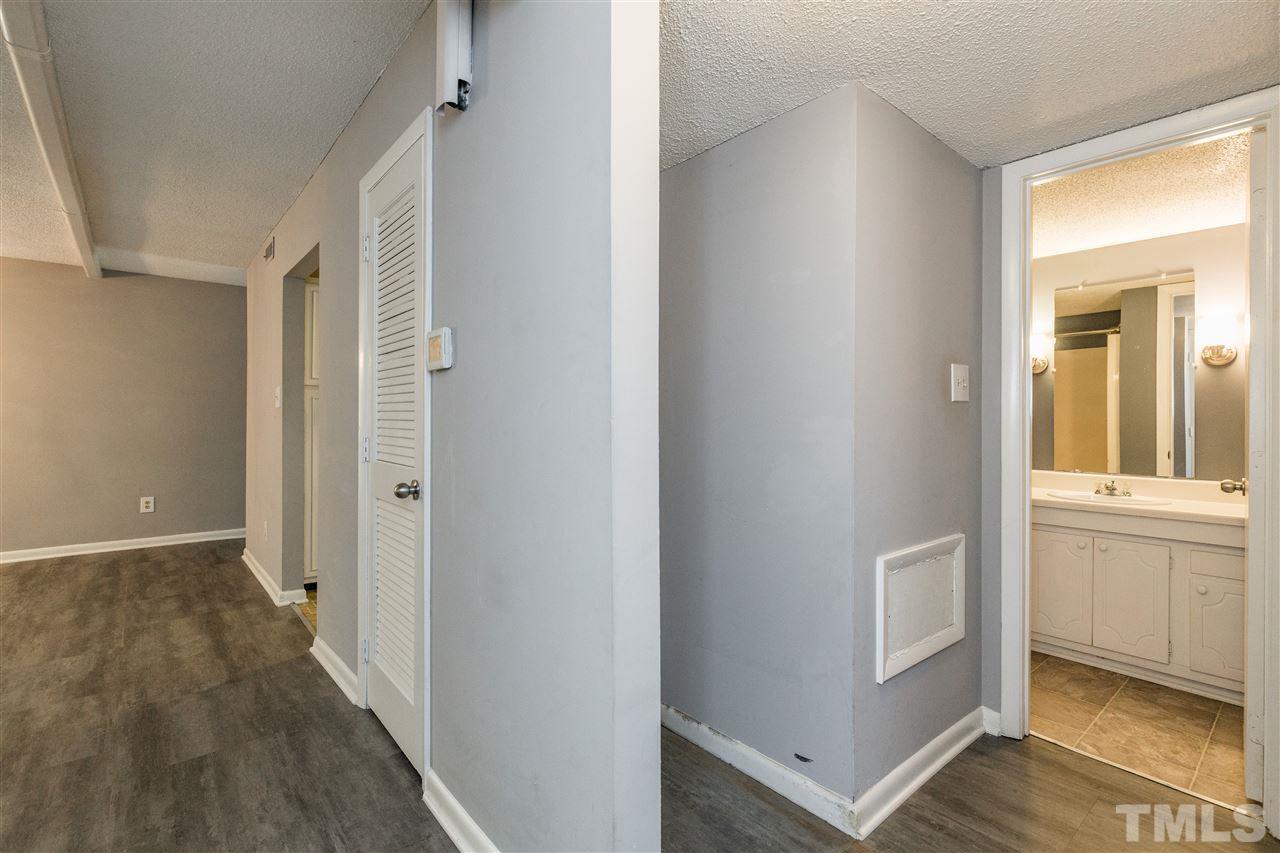 611 Pine Ridge Place, Unit 611 Raleigh, NC 27609 - Photo 22 of 26 a view of a hallway with wooden floor and closet