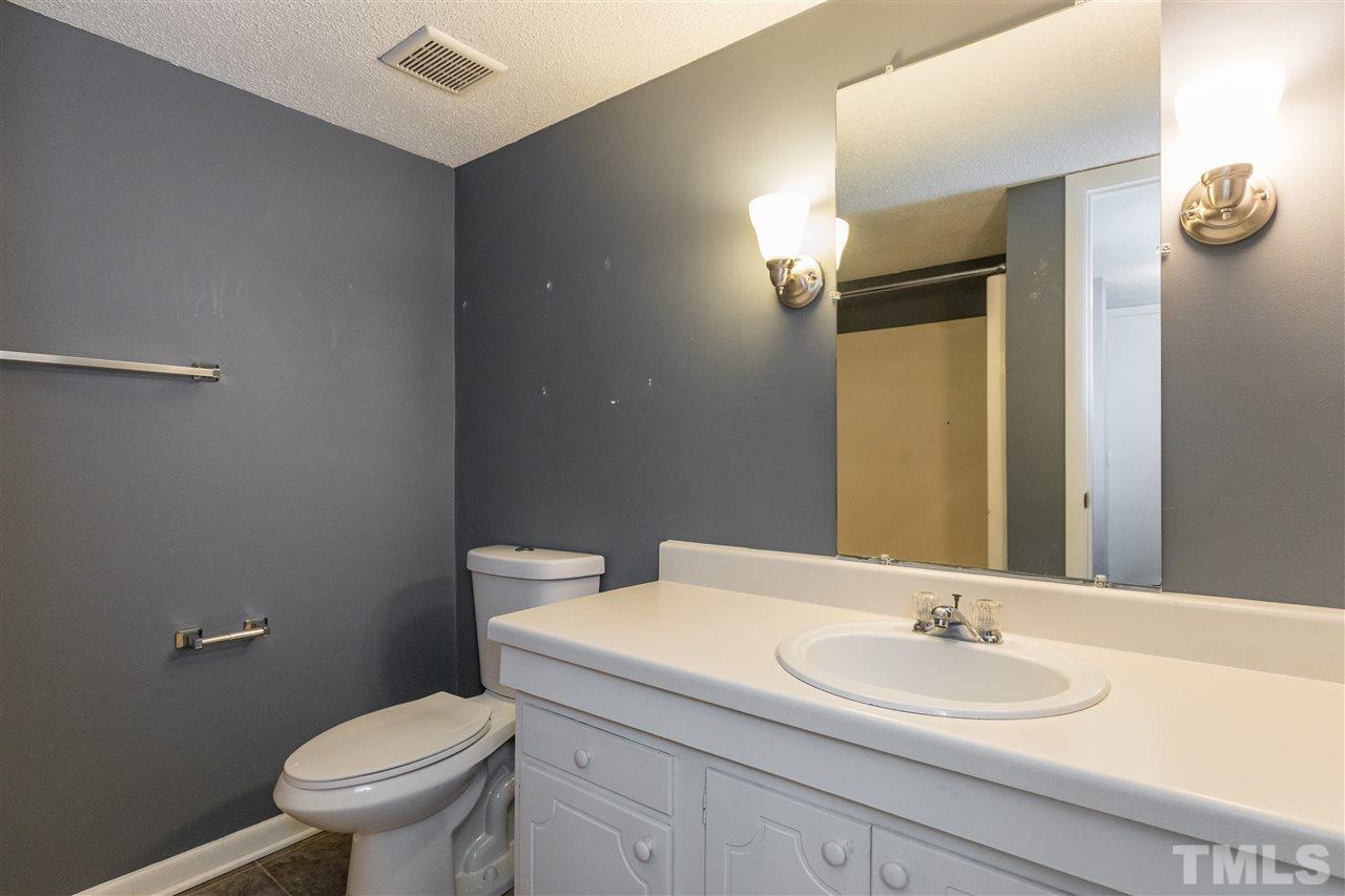 611 Pine Ridge Place, Unit 611 Raleigh, NC 27609 - Photo 23 of 26 a bathroom with a granite countertop sink toilet and mirror