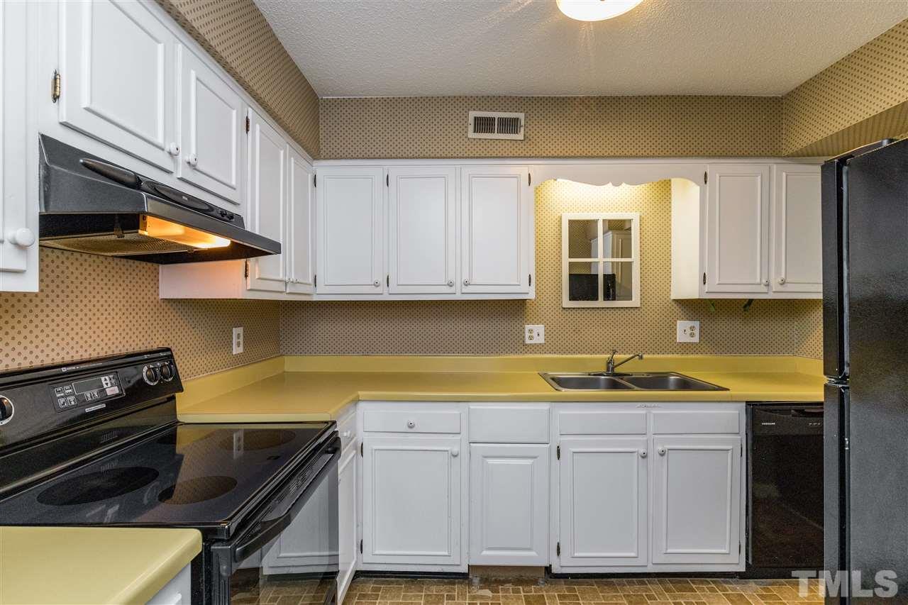 611 Pine Ridge Place, Unit 611 Raleigh, NC 27609 - Photo 7 of 26 a kitchen with stainless steel appliances granite countertop a sink and cabinets