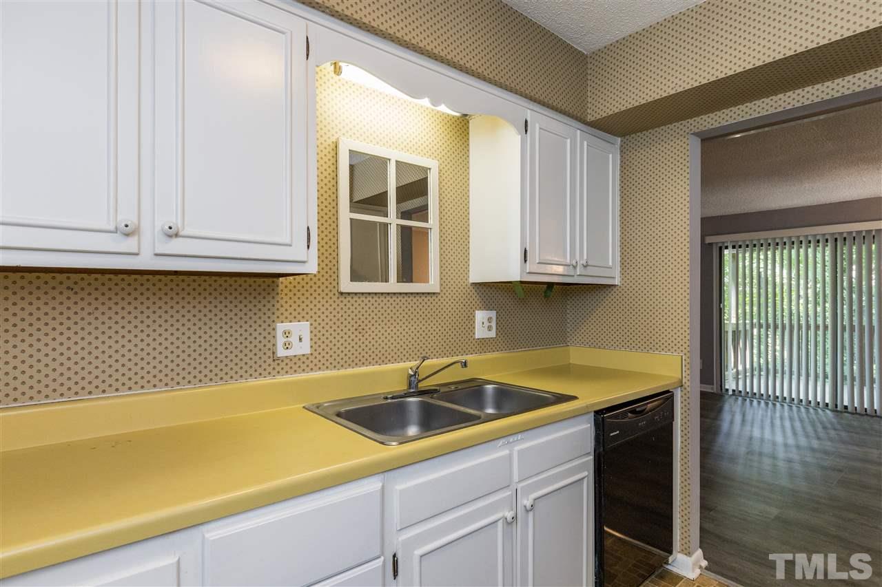 611 Pine Ridge Place, Unit 611 Raleigh, NC 27609 - Photo 8 of 26 a kitchen with a sink and cabinets