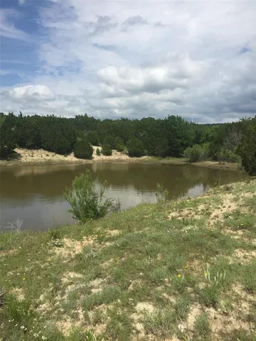 a view of a lake with houses in back