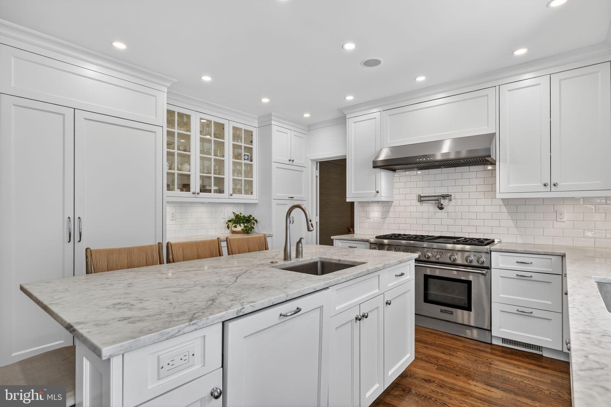 4340 Garfield Street Northwest Washington, DC 20007 - Photo 12 of 42 a kitchen with stainless steel appliances granite countertop a stove sink and cabinets