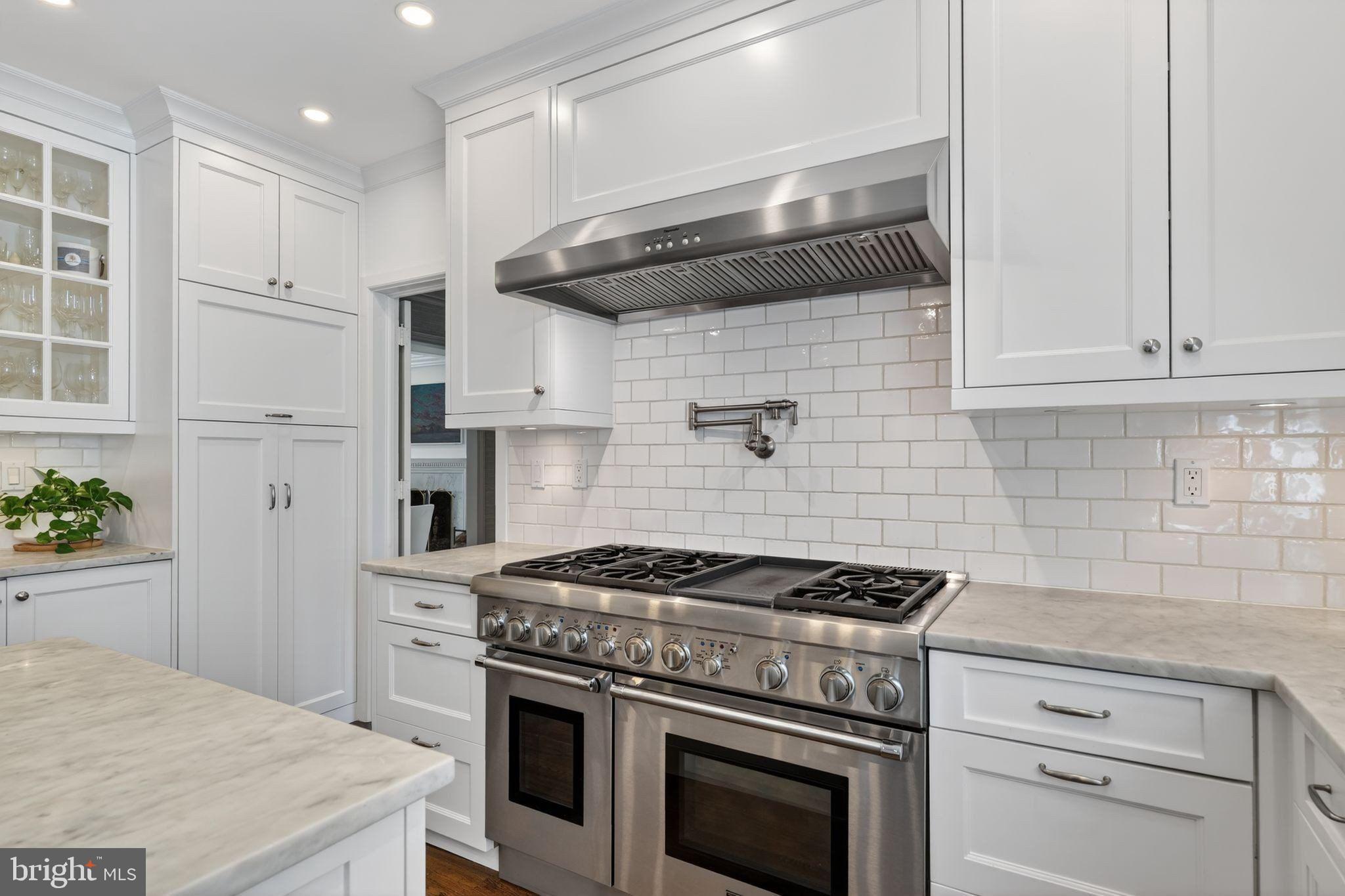 4340 Garfield Street Northwest Washington, DC 20007 - Photo 13 of 42 a kitchen with stainless steel appliances granite countertop a stove a refrigerator and a white cabinets