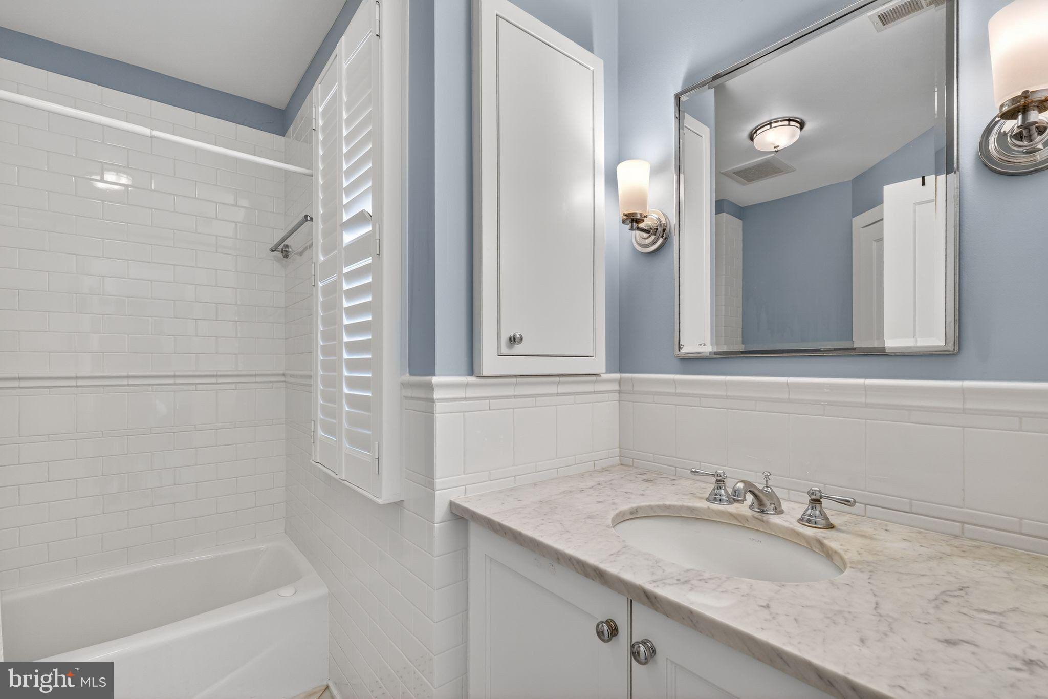 4340 Garfield Street Northwest Washington, DC 20007 - Photo 28 of 42 a bathroom with a granite countertop sink and a mirror