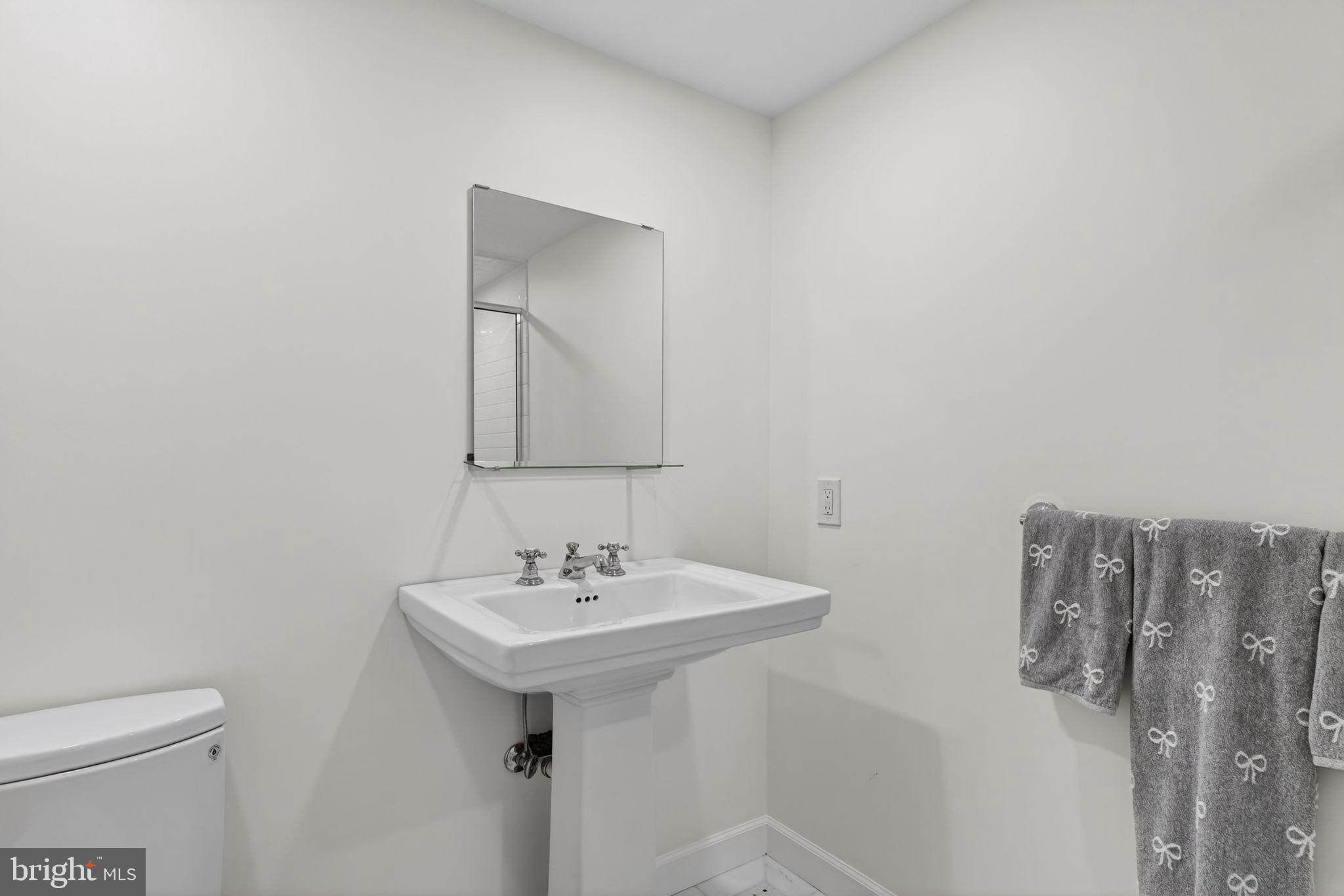 4340 Garfield Street Northwest Washington, DC 20007 - Photo 35 of 42 a bathroom with a sink a toilet and mirror