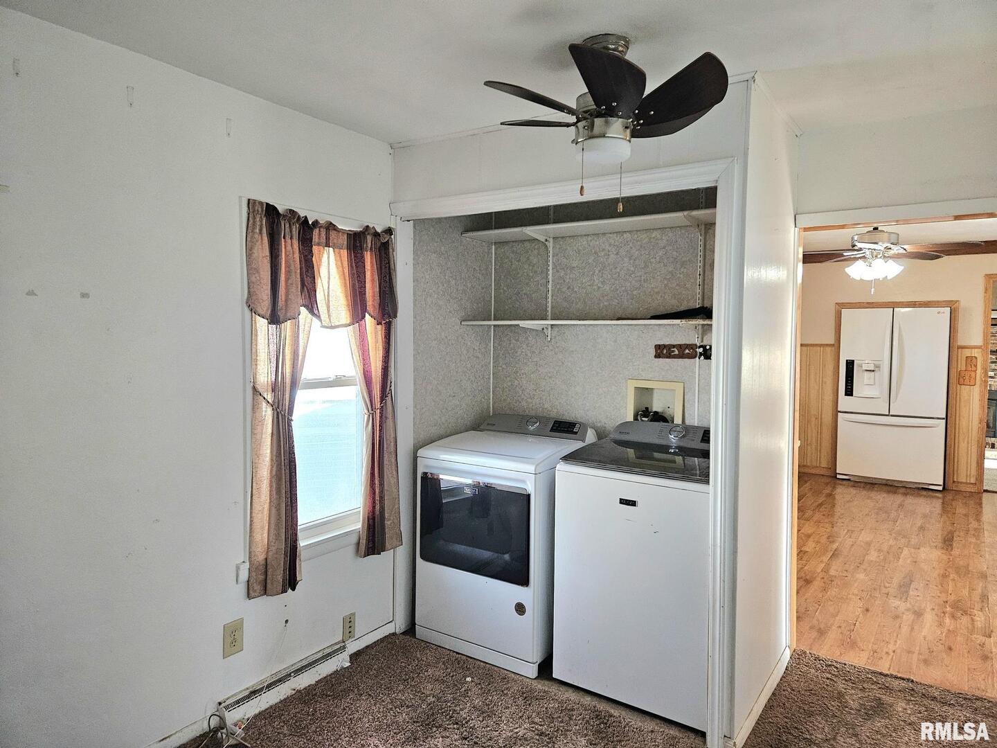 313 East 3rd Street Wilton, IA 52778 - Photo 12 of 14 a kitchen with a stove and a refrigerator