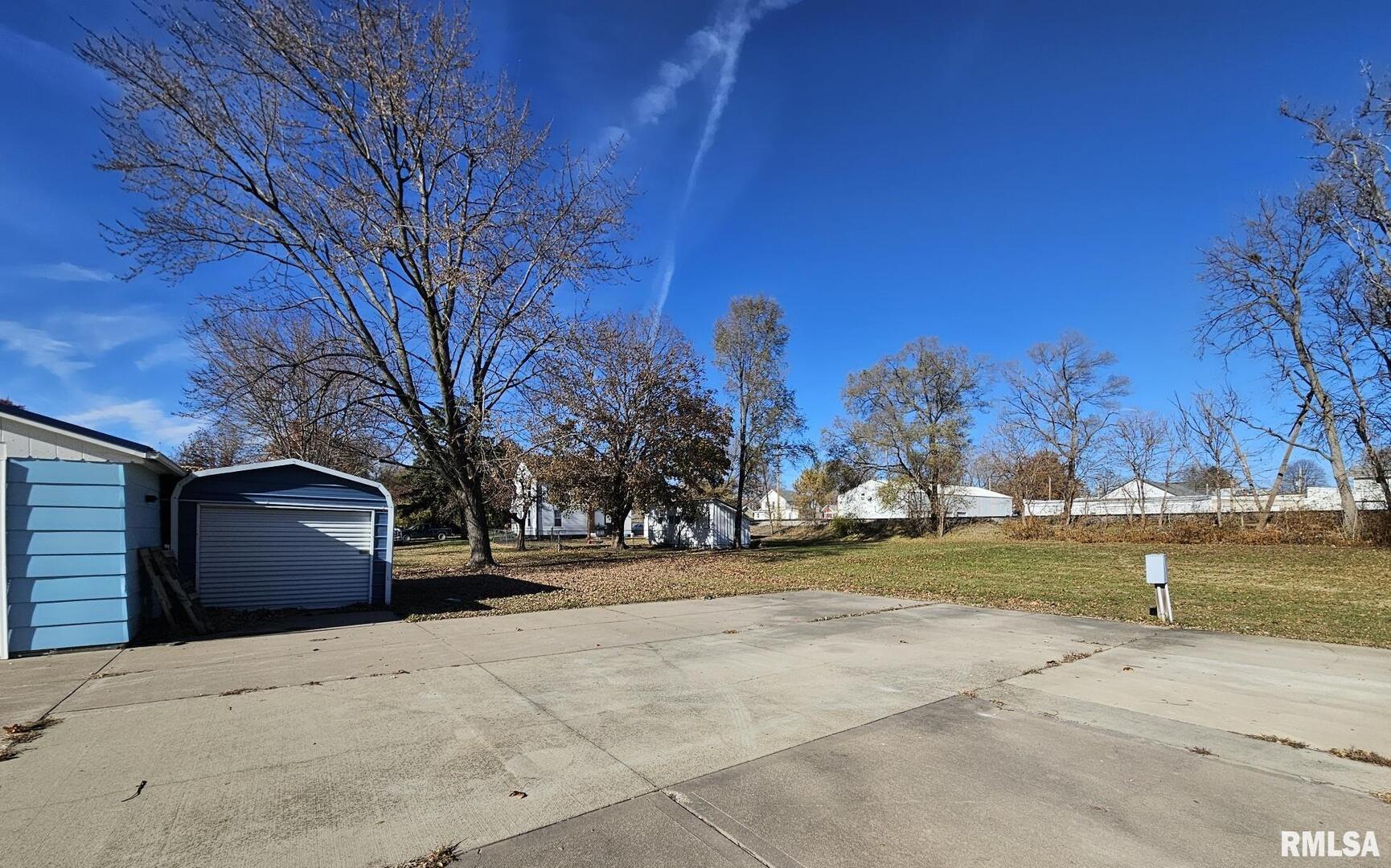 313 East 3rd Street Wilton, IA 52778 - Photo 5 of 14 a view of a house with a yard and large tree