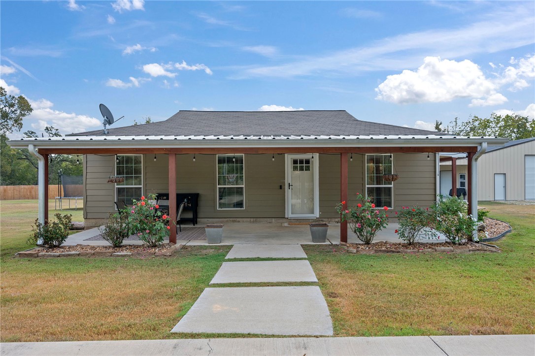 7766 Grassbur Road Bryan, TX 77808 - Photo 1 of 1 View of front of home featuring a front lawn and covered porch