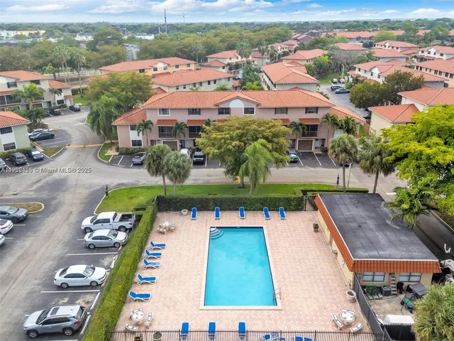 an aerial view of a house with yard swimming pool and ocean view