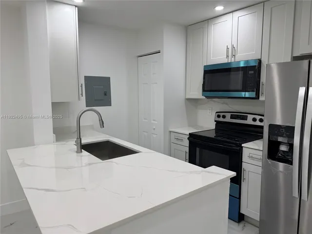 a view of a house with a large space and a large tree