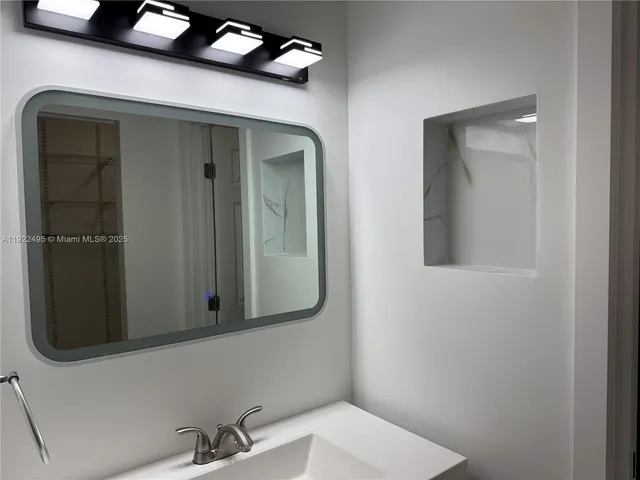 a kitchen with stainless steel appliances a refrigerator a sink a stove a microwave and wooden cabinets