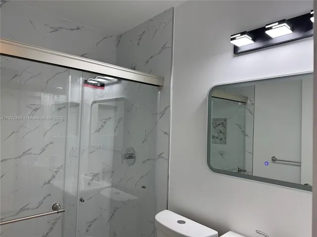 a bathroom with a shower and toilet