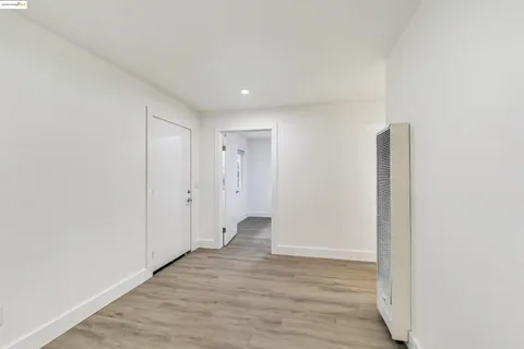 a view of hallway with wooden floor