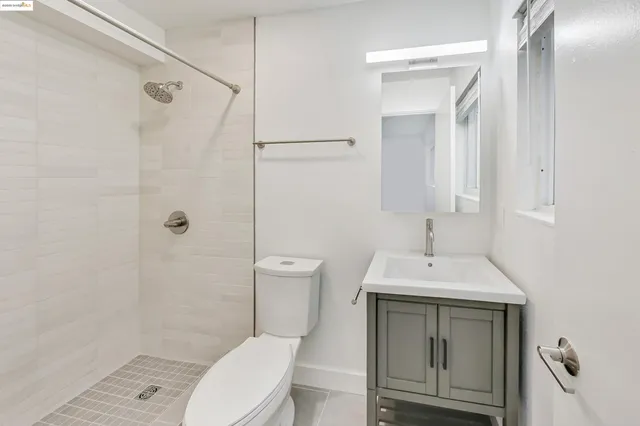 a bathroom with a toilet a sink and a shower